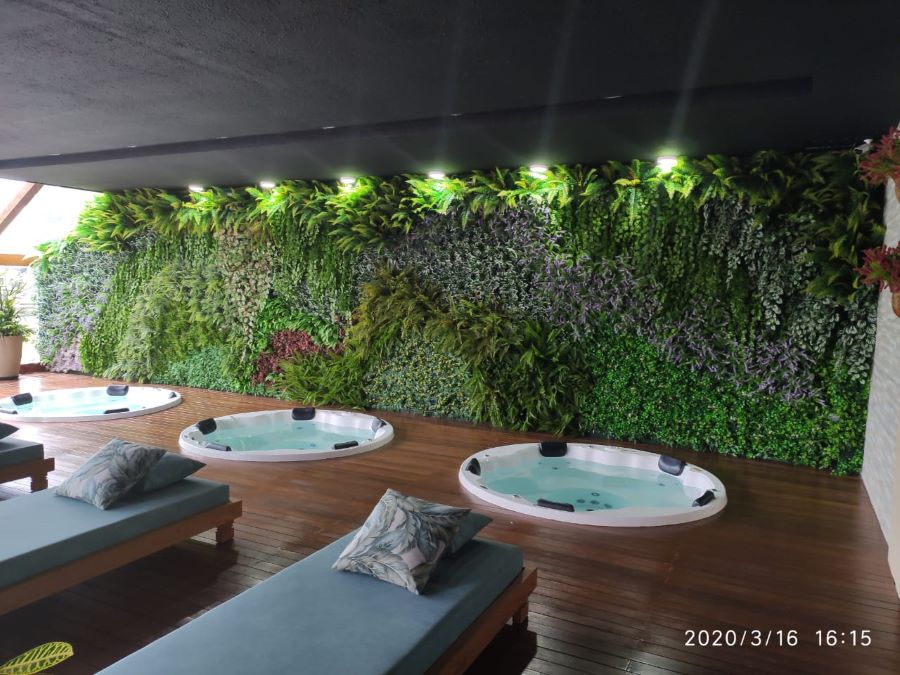 Seja com plantas naturais ou artificiais, a parede com jardim vertical é uma excelente maneira de dar destaque a um ambiente. 